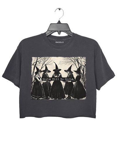 Ragglo dark gray women's crop top featuring five witches in black hats holding a sign with the text 'Girls Will Be Girls' in a spooky forest background.