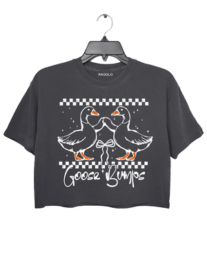 A dark gray cropped t-shirt from Ragglo featuring a "Goose Bumps" design with two geese in a playful pose, surrounded by a checkered pattern and stars.

