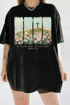 Ragglo black women's t-shirt with 'He Is Not Here, He Has Risen' text and cross on hill with wildflowers graphic.