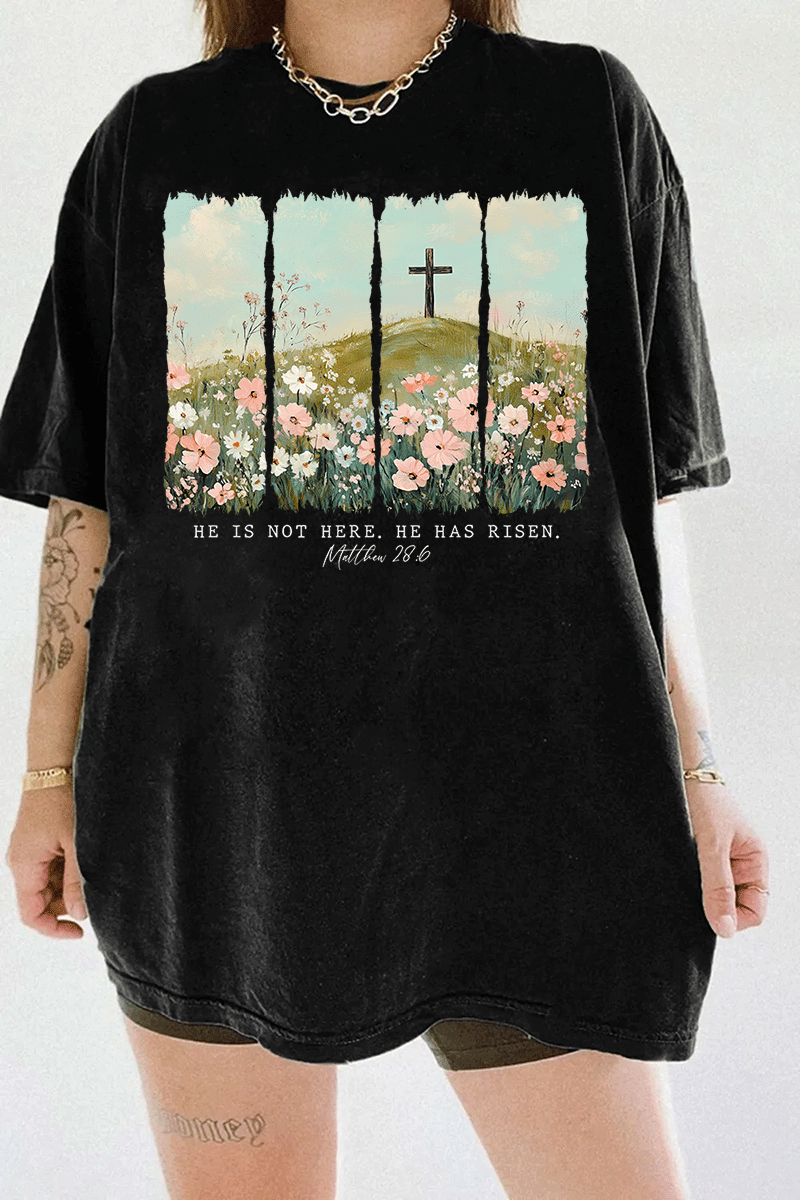 Ragglo black women's t-shirt with 'He Is Not Here, He Has Risen' text and cross on hill with wildflowers graphic.