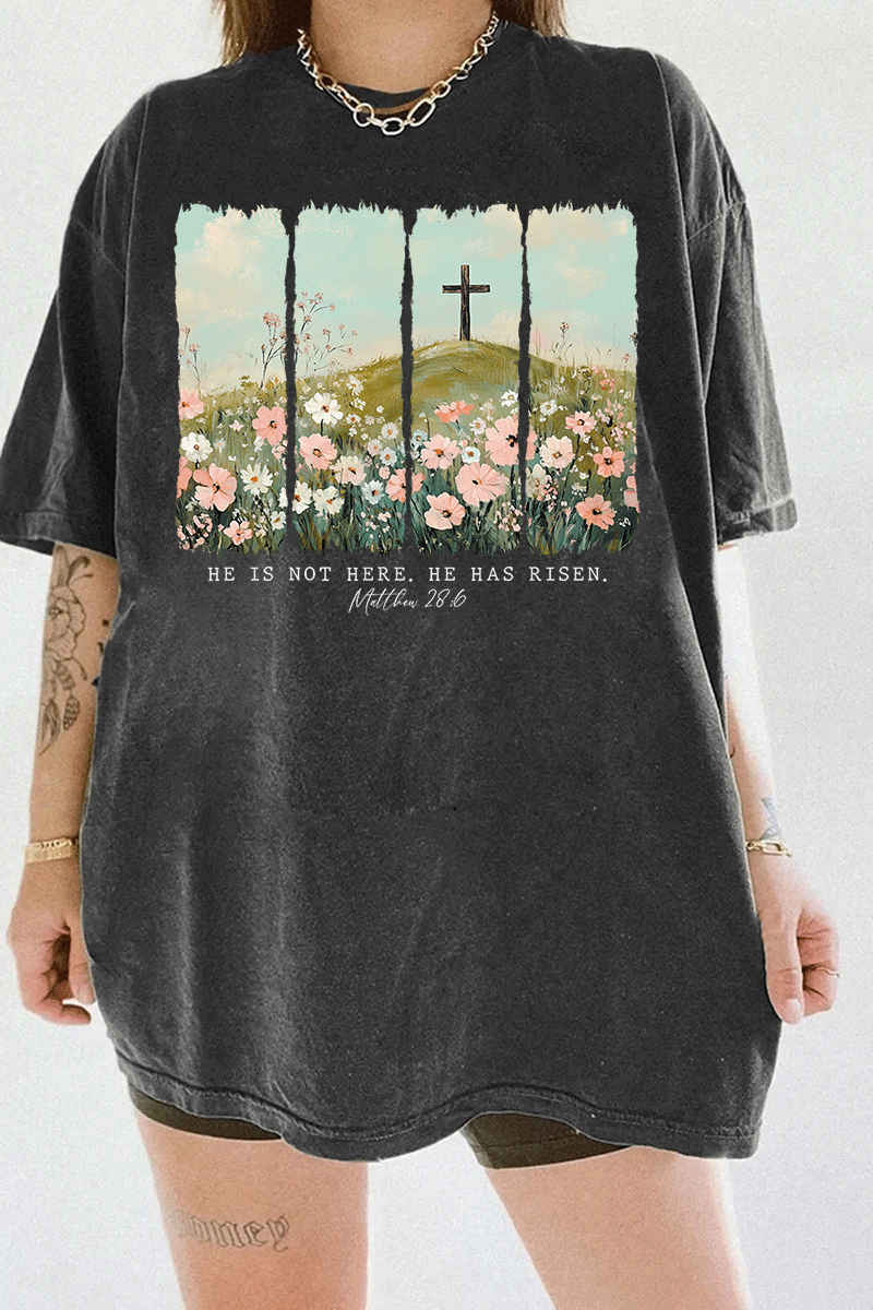 Ragglo dark gray women's t-shirt with 'He Is Not Here, He Has Risen' text and cross on hill with wildflowers graphic.