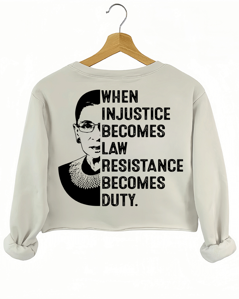 A beige sweatshirt from Ragglo with a silhouette of Ruth Bader Ginsburg and the text "WHEN INJUSTICE BECOMES LAW RESISTANCE BECOMES DUTY." on the back.

