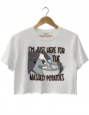 Funny white cropped t-shirt with "I'm Just Here for the Mashed Potatoes" text and a hand mixing mashed potatoes graphic, perfect for Thanksgiving or food lovers.

