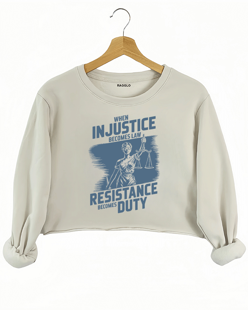 Ragglo beige crop sweatshirt with light blue 'When Injustice Becomes Law, Resistance Becomes Duty' slogan and Lady Justice design pattern
