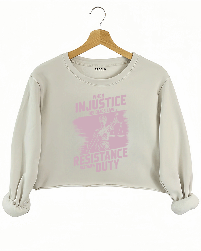 Ragglo beige crop sweatshirt with light pink 'When Injustice Becomes Law, Resistance Becomes Duty' slogan and Lady Justice design pattern