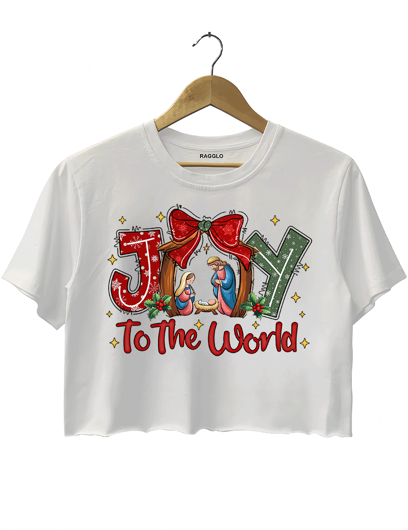 Ragglo white crop top featuring 'JOY TO THE WORLD' text with a nativity scene, a red bow, and holly leaves, perfect for religious Christmas streetwear and festive celebrations.




