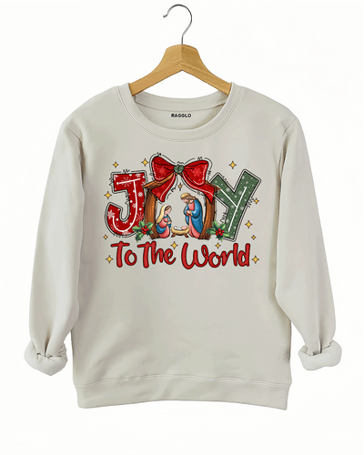 Ragglo beige sweatshirt featuring 'JOY TO THE WORLD' text with a nativity scene, a red bow, and holly leaves, perfect for religious Christmas streetwear and festive celebrations.







