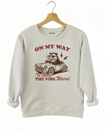 Ragglo beige women's sweatshirt with skeleton reading book graphic surrounded by flowers and butterflies.

