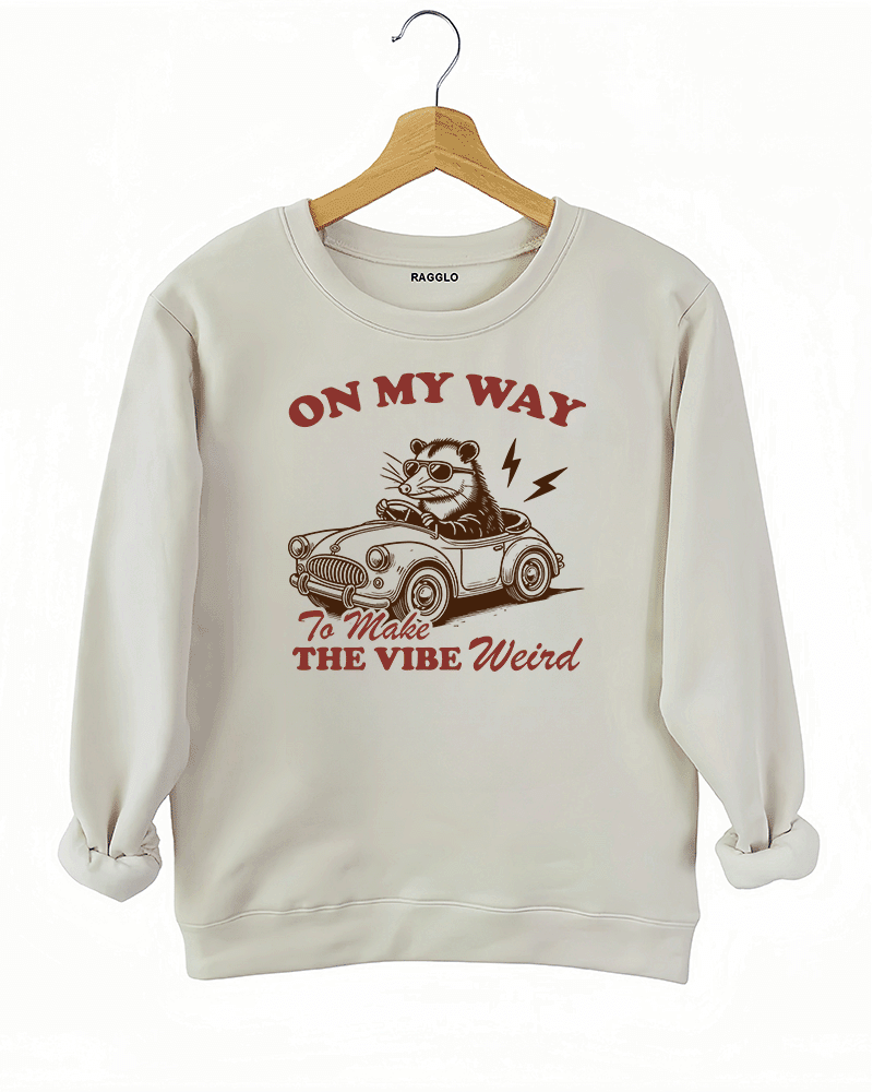 Ragglo beige women's sweatshirt with skeleton reading book graphic surrounded by flowers and butterflies.

