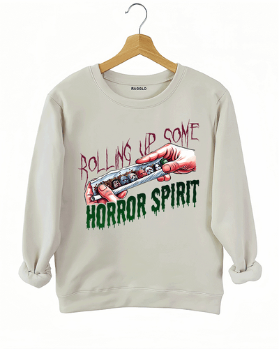 Ragglo beige sweatshirt featuring a hand rolling a cigarette with horror movie characters' faces, with 'ROLLING UP SOME HORROR SPIRIT' text, perfect for Halloween streetwear for horror movie fans.

