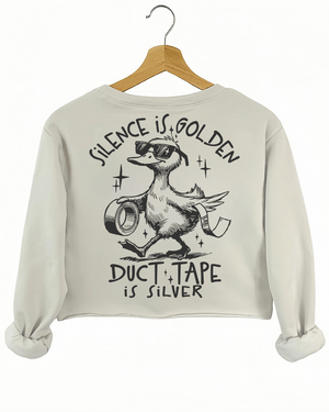 Ragglo beige women's crop sweatshirt back featuring a duck with sunglasses holding duct tape and the text 'Duct Tape is Silver' in a playful graphic design.