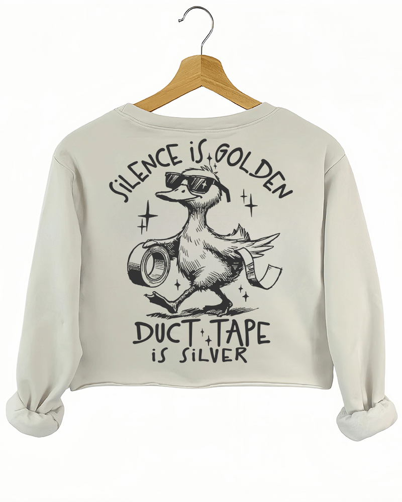 Ragglo beige women's crop sweatshirt back featuring a duck with sunglasses holding duct tape and the text 'Duct Tape is Silver' in a playful graphic design.
