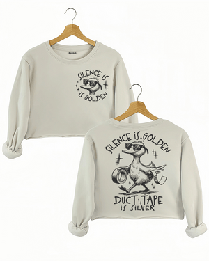 Ragglo beige women's crop sweatshirt featuring a cool duck with sunglasses on both front and back, with 'Silence is Golden' on the front and 'Duct Tape is Silver' with a duck holding duct tape on the back, in a humorous graphic design