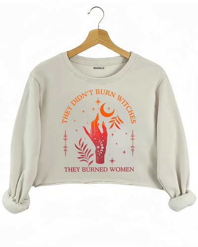 Ragglo beige women's crop sweatshirt with 'They Didn’t Burn Witches, They Burned Women' text and flaming hand with mystical symbols graphic.

