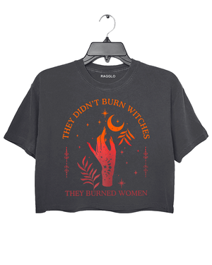 Ragglo dark gray women's crop top with 'They Didn’t Burn Witches, They Burned Women' text and flaming hand with mystical symbols graphic.

