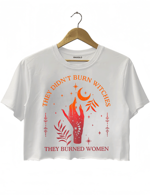 Ragglo white women's crop top with 'They Didn’t Burn Witches, They Burned Women' text and flaming hand with mystical symbols graphic.

