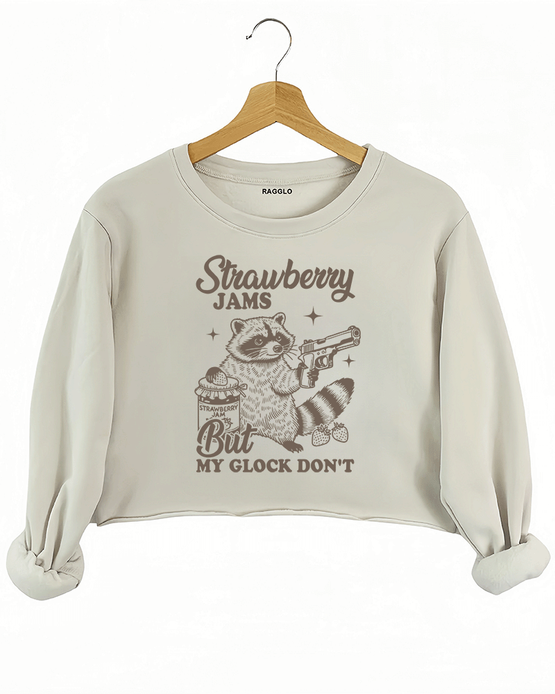 Ragglo women's beige crop sweatshirt with cute gray 'Strawberry Jams But MY GLOCK DON'T' raccoon graphic

