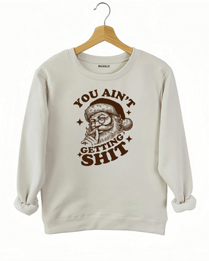 Beige Ragglo women's sweatshirt made of soft fleece, featuring a Santa Claus graphic with the text "YOU AIN'T GETTING SHIT" in brown, hanging on a wooden hanger.

