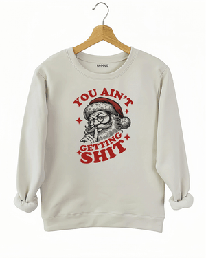 Beige Ragglo women's sweatshirt made of soft fleece, featuring a Santa Claus graphic with the text "YOU AIN'T GETTING SHIT" in red and black, hanging on a wooden hanger.


