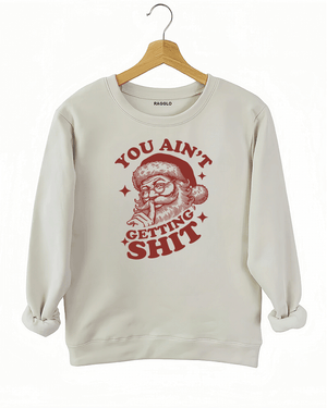 Beige Ragglo women's sweatshirt made of soft fleece, featuring a Santa Claus graphic with the text "YOU AIN'T GETTING SHIT" in red, hanging on a wooden hanger.

