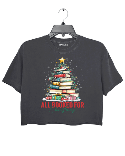Ragglo dark gray crop top featuring a Christmas tree made of stacked books, decorated with lights, stars, and gifts, with 'ALL BOOKED FOR CHRISTMAS' text, perfect for festive streetwear for book lovers.

