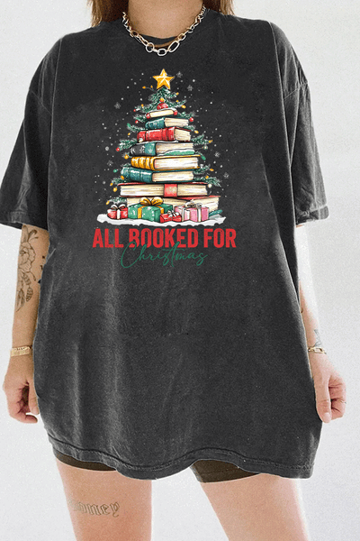 Ragglo dark gray tee featuring a Christmas tree made of stacked books, decorated with lights, stars, and gifts, with 'ALL BOOKED FOR CHRISTMAS' text, perfect for festive streetwear for book lovers.

