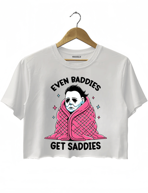 Ragglo white crop top featuring Michael Myers wrapped in a pink blanket with stars, with 'EVEN BADDIES GET SADDIES' text, perfect for horror movie fans and mental health awareness streetwear.

