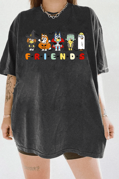 Ragglo dark gray tee featuring five Bluey characters in Halloween costumes as a witch, vampire, Frankenstein, construction worker, and ghost, with 'F·R·I·E·N·D·S' text in a Friends-inspired font, perfect for cute Halloween streetwear for animation fans.

