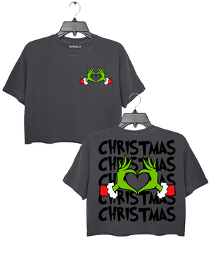 Ragglo dark gray women's crop top featuring Grinch hands making a heart shape with Santa cuffs on the front, and larger Grinch hands with 'Christmas' text repeated around them on the back, in a funny holiday graphic design.