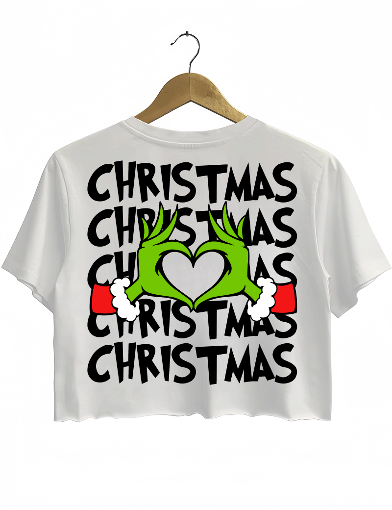 Ragglo white women's crop top back featuring larger Grinch hands making a heart shape with Santa cuffs, surrounded by the repeated text 'Christmas' in a humorous holiday graphic design.