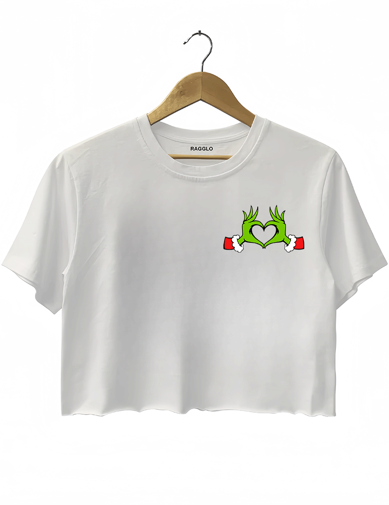Ragglo white women's crop top front featuring Grinch hands making a heart shape with Santa cuffs in a playful Christmas design.