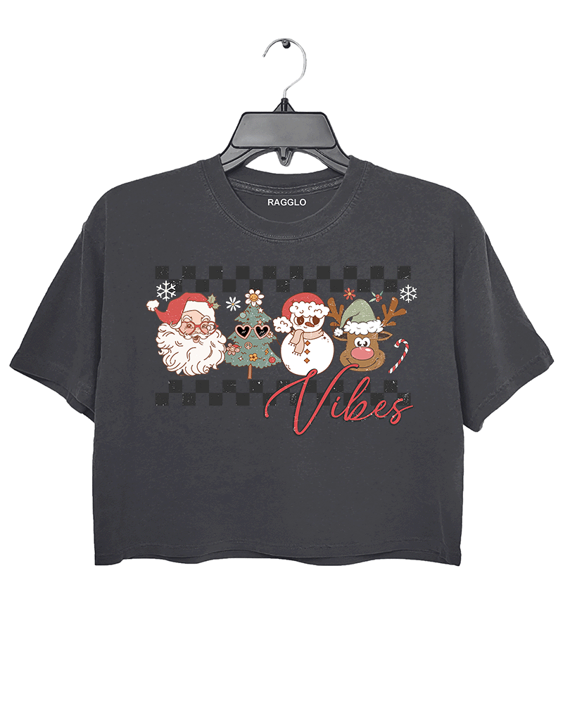 Ragglo dark gray crop top with "Vibes" text and Christmas graphic featuring Santa, snowman, and reindeer, showcasing a festive holiday theme with a checkered background.

