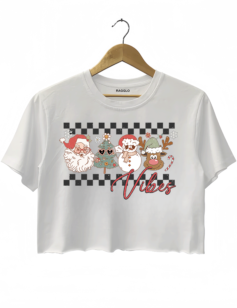 Ragglo white crop top with "Vibes" text and Christmas graphic featuring Santa, snowman, and reindeer, showcasing a festive holiday theme with a checkered background.


