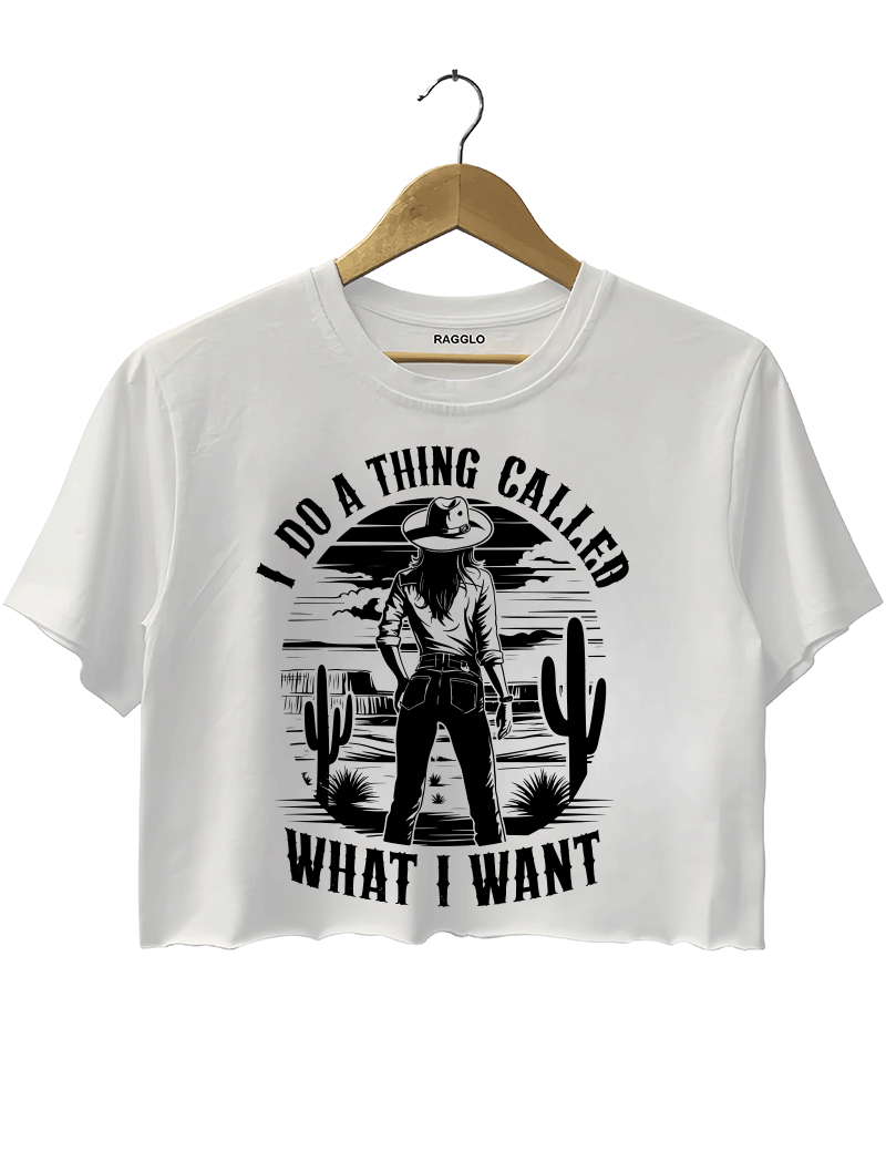 Ragglo white crop top featuring a cowgirl in a desert with cacti and a sunset, with 'I DO A THING CALLED WHAT I WANT' text, perfect for western-inspired streetwear for free spirits.

