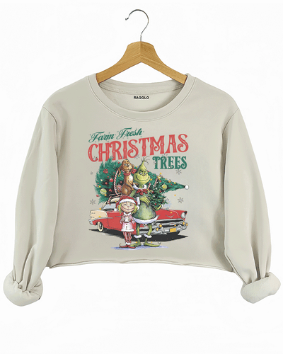 Ragglo beige crop sweatshirt featuring The Grinch, Cindy Lou Who, and Max with a decorated Christmas tree and vintage car, with 'FARM FRESH CHRISTMAS TREES' text, perfect for festive holiday streetwear.

