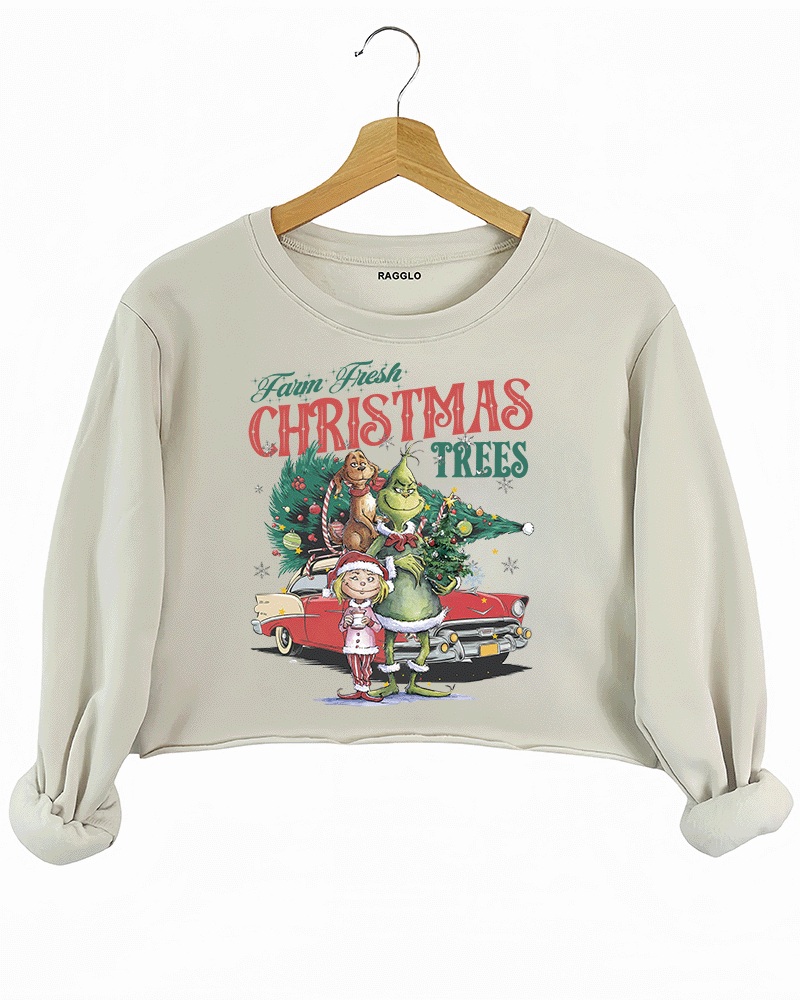 Ragglo beige crop sweatshirt featuring The Grinch, Cindy Lou Who, and Max with a decorated Christmas tree and vintage car, with 'FARM FRESH CHRISTMAS TREES' text, perfect for festive holiday streetwear.

