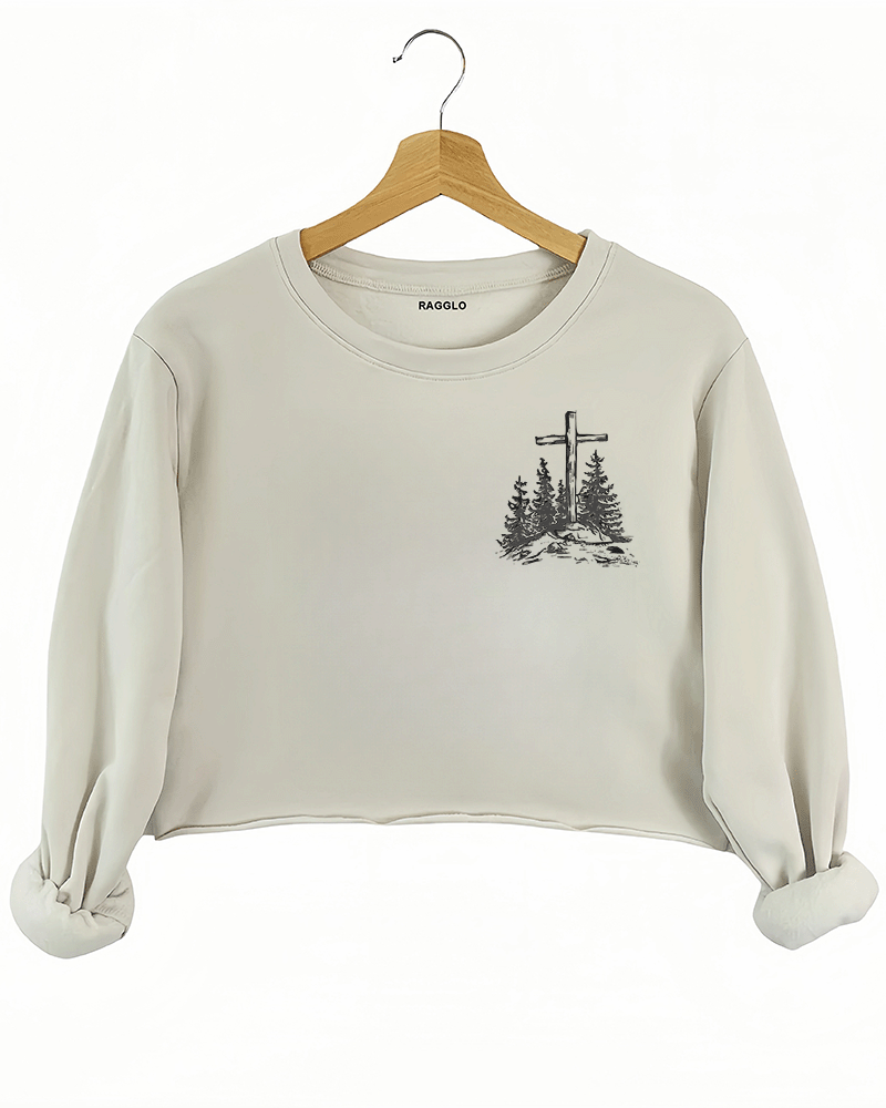 Ragglo beige women's crop sweatshirt front featuring a minimalist design with a cross and trees in a faith-inspired style.