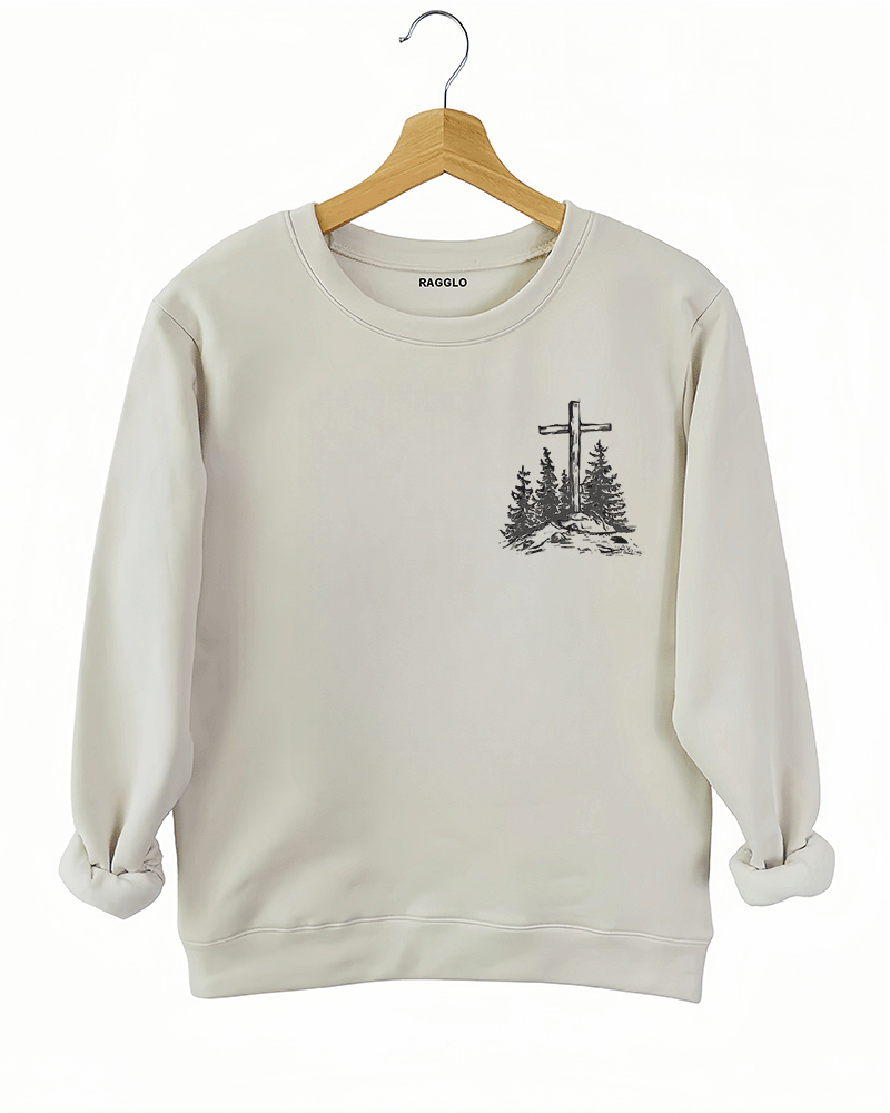 Ragglo beige women's sweatshirt front featuring a minimalist design with a cross and trees in a faith-inspired style.