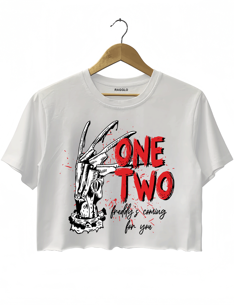 Ragglo white women's crop top with Freddy Krueger claw graphic and "One Two Freddy's Coming For You" text, inspired by A Nightmare on Elm Street horror theme.

