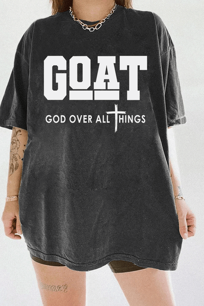 Ragglo dark gray T-shirt with "GOAT God Over All Things" text and cross symbol in white, featuring a Christian faith-inspired design.

