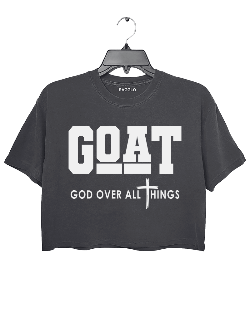 Ragglo dark gray crop top with "GOAT God Over All Things" text and cross symbol in white, featuring a Christian faith-inspired design.

