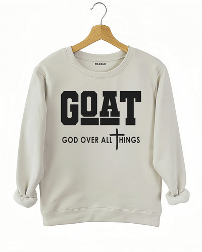 Ragglo beige sweatshirt with "GOAT God Over All Things" text and cross symbol in white, featuring a Christian faith-inspired design.

