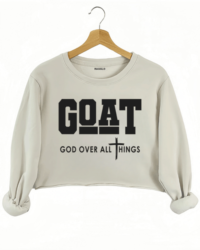 Ragglo beige crop sweatshirt with "GOAT God Over All Things" text and cross symbol in white, featuring a Christian faith-inspired design.

