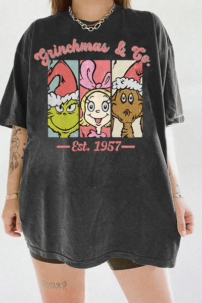 Ragglo dark gray T-shirt featuring The Grinch, Cindy Lou Who, and Max in Santa hats with 'GRINCHMAS & GO' text and 'EST. 1957', perfect for festive holiday streetwear and Grinch fans.

