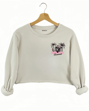 Ragglo beige crop sweatshirt front view with 'HAWK TUAH FERAL GIRL SUMMER' text and palm trees, ideal for playful summer streetwear.

