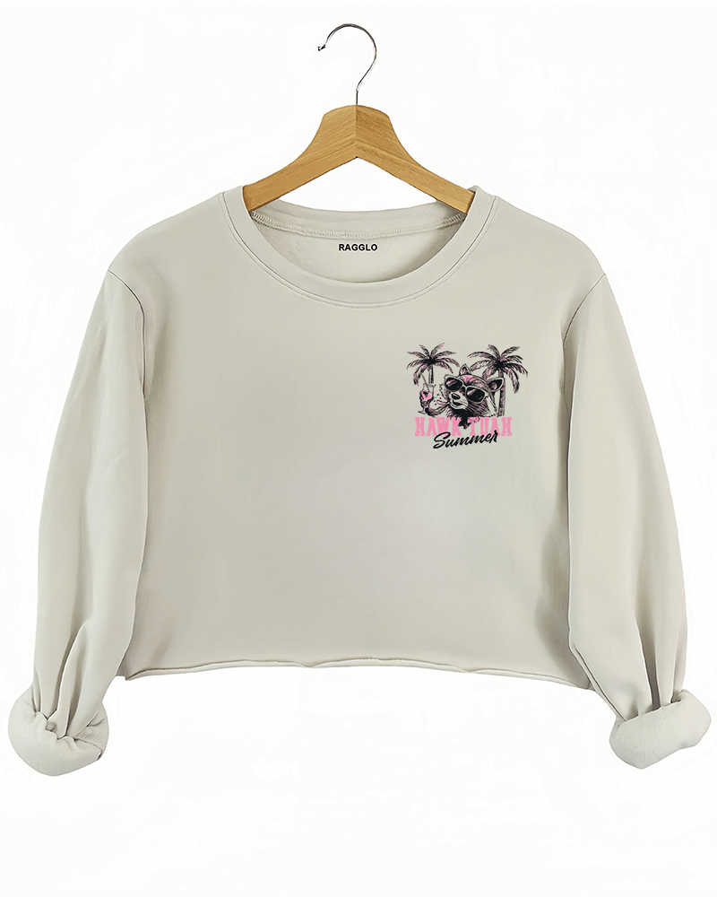 Ragglo beige crop sweatshirt front view with 'HAWK TUAH FERAL GIRL SUMMER' text and palm trees, ideal for playful summer streetwear.

