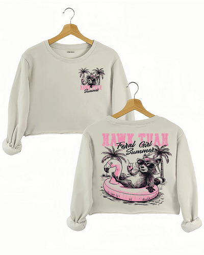 Ragglo beige crop sweatshirt front and back view, featuring a raccoon in sunglasses on a flamingo float with 'HAWK TUAH FERAL GIRL SUMMER' text and palm trees, perfect for playful vacation streetwear.



