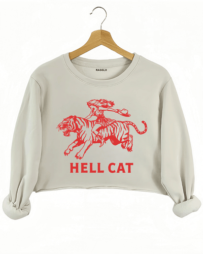 Ragglo beige crop sweatshirt featuring 'HELL CAT' text in red with a graphic of a woman riding a tiger, perfect for bold streetwear and fierce, rebellious vibes.





