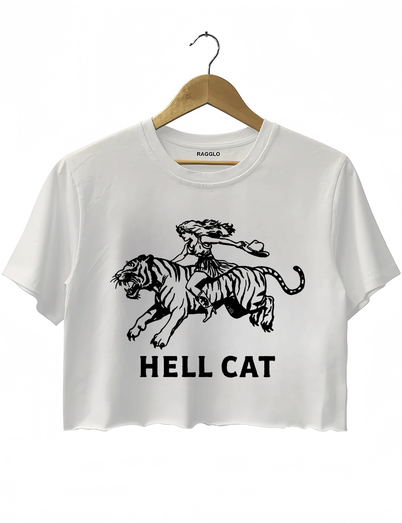 Ragglo white crop top featuring 'HELL CAT' text in black with a graphic of a woman riding a tiger, perfect for bold streetwear and fierce, rebellious vibes.



