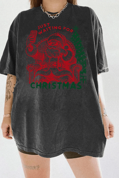Ragglo dark gray T-shirt featuring a Santa selfie graphic with sunglasses, a Christmas tree, and 'JUST WAITING FOR CHRISTMAS' text, perfect for festive holiday streetwear and fun celebrations.

